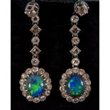 A pair of earrings, having oval opals within a surround of diamonds, on a diamond suspension, in a