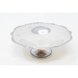 A silver pedestal dish, of shaped circular form, with engraved ribbon and swag decoration,