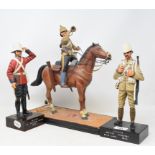 A carved and painted wood model, of a soldier on horseback, 36 cm high, and two figures, the bases