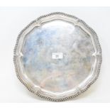 An 18th century style silver salver, inscribed and dated '56, on three scroll feet, Elkington,