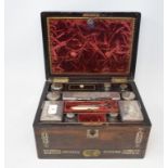 A Victorian travelling dressing case, with silver plated mounts, the rosewood case inlaid with