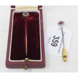 A sapphire and diamond stick pin, cased, and another stick pin (2) Report by RB The diamond and