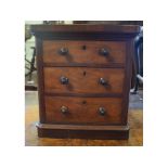 A pair of mahogany table top chests, with three graduated long drawers, on plinth bases, 29 cm