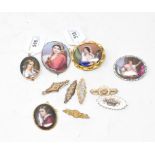 A late 19th century oval porcelain plaque, decorated a musician, other porcelain plaque brooches and