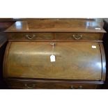 An Edwardian inlaid mahogany cylinder desk, on tapering square legs joined by a shaped undertier, 75