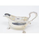 An 18th century style silver sauce boat, crested, on shell capped pad feet, London 1873, approx.