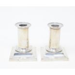 A pair of Victorian silver dwarf candlesticks, London 1873, 9.5 cm high (2) Report by GH Some