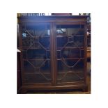 An Edwardian inlaid mahogany bookcase, having a pair of bar glazed doors, on bracket feet, 123 cm