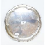 A silver salver, of shaped circular form, with a bead and scroll border, Birmingham 1931, approx.