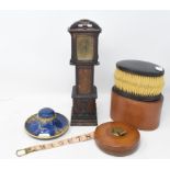 A miniature longcase clock, in an inlaid case, 31 cm high, a Carlton Ware inkstand, a leather