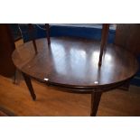 A mahogany oval extending dining table, with two extra leaves, 234 cm wide