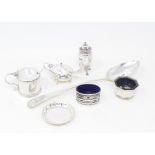 A silver mustard pot, Birmingham 1930, other silver condiments and a silver serving spoon