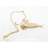 An articulated fish pendant, on a chain Report by RB There are no hallmarks on this pendant, we