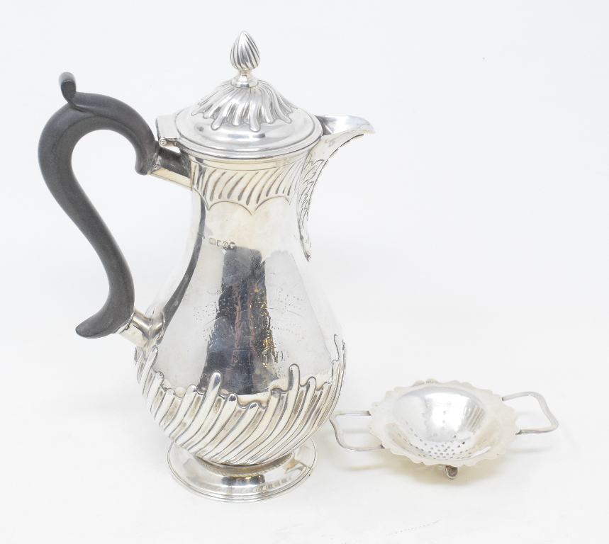 A Victorian silver hot water jug, with presentation inscription, London 1889, marks rubbed, and a