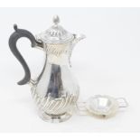 A Victorian silver hot water jug, with presentation inscription, London 1889, marks rubbed, and a