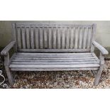 A pair of teak garden benches