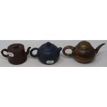 A Yixing pottery teapot, decorated calligraphy, 9 cm high, and two others (3)