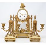 A clock garniture, the clock having a 10 cm diameter enamel dial with Arabic numerals, fitted an