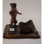 A painted bronze group, in the form of a pug with a bag on a rug, 19 cm wide Modern
