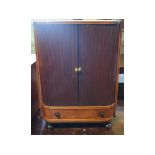 A Regency inlaid mahogany table top cabinet, having a pair of tambour doors above a drawer, on