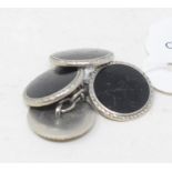 A pair of platinum and onyx cufflinks