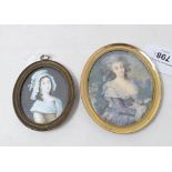 A late 18th/early 19th century oval portrait miniature, of a seated lady with a blue ribbon in her