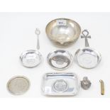 A silver coloured metal dish, inset a coin, a bowl, and other items
