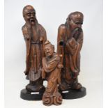 A Chinese carved rootwood figure, 46 cm high, and two others (3)