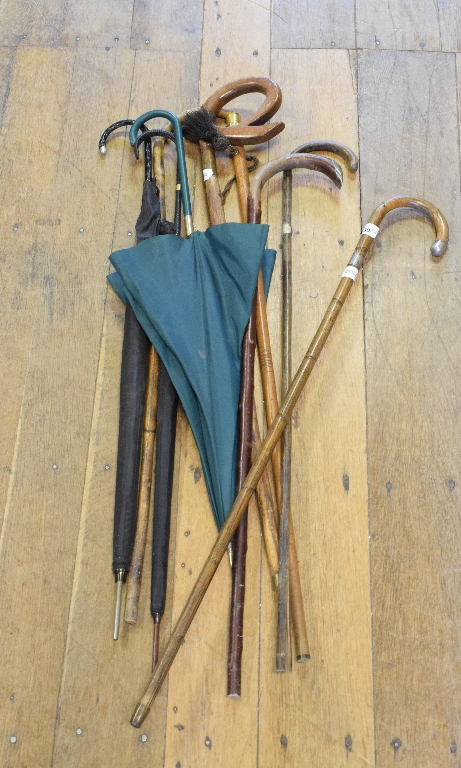 A Liberty parasol, other parasols and assorted walking sticks (qty)