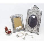 A silver photograph frame, with relief floral decoration, London 1991, another photograph frame, a