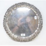 A late 19th century silver salver, the border decorated foliage and shells, on three scroll feet,
