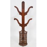 A cast iron stick stand, of demi lune form with stylised floral and foliate decoration, with an