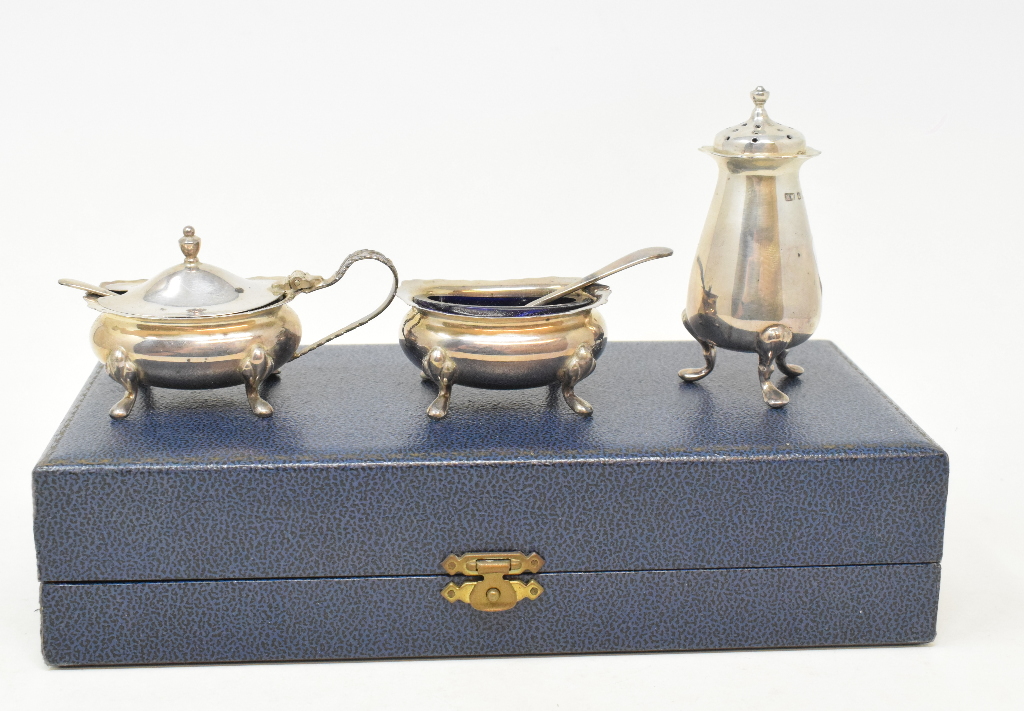 A silver three piece condiment set, Birmingham 1992, cased, and assorted silver plated items