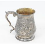 A George III silver mug, initialled, of baluster form, embossed flowers and foliage, London 1766,