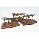 Three sets of postal scales, a silver backed dressing table set, cased, and a tripod stand (5)
