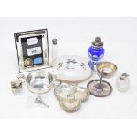 A silver armada dish, Sheffield 2000, a silver ring stand, and other small items of silver,