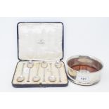 A silver wine bottle coaster, London 2000, and a set of six silver coffee spoons, cased (2)