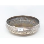 An Islamic silver coloured metal bowl, with scrolling foliage decoration, 28 cm diameter