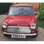 A 1986 Austin Mini 1000 Chelsea, registration number C150 FKJ, red. Introduced in 1985, the Mini