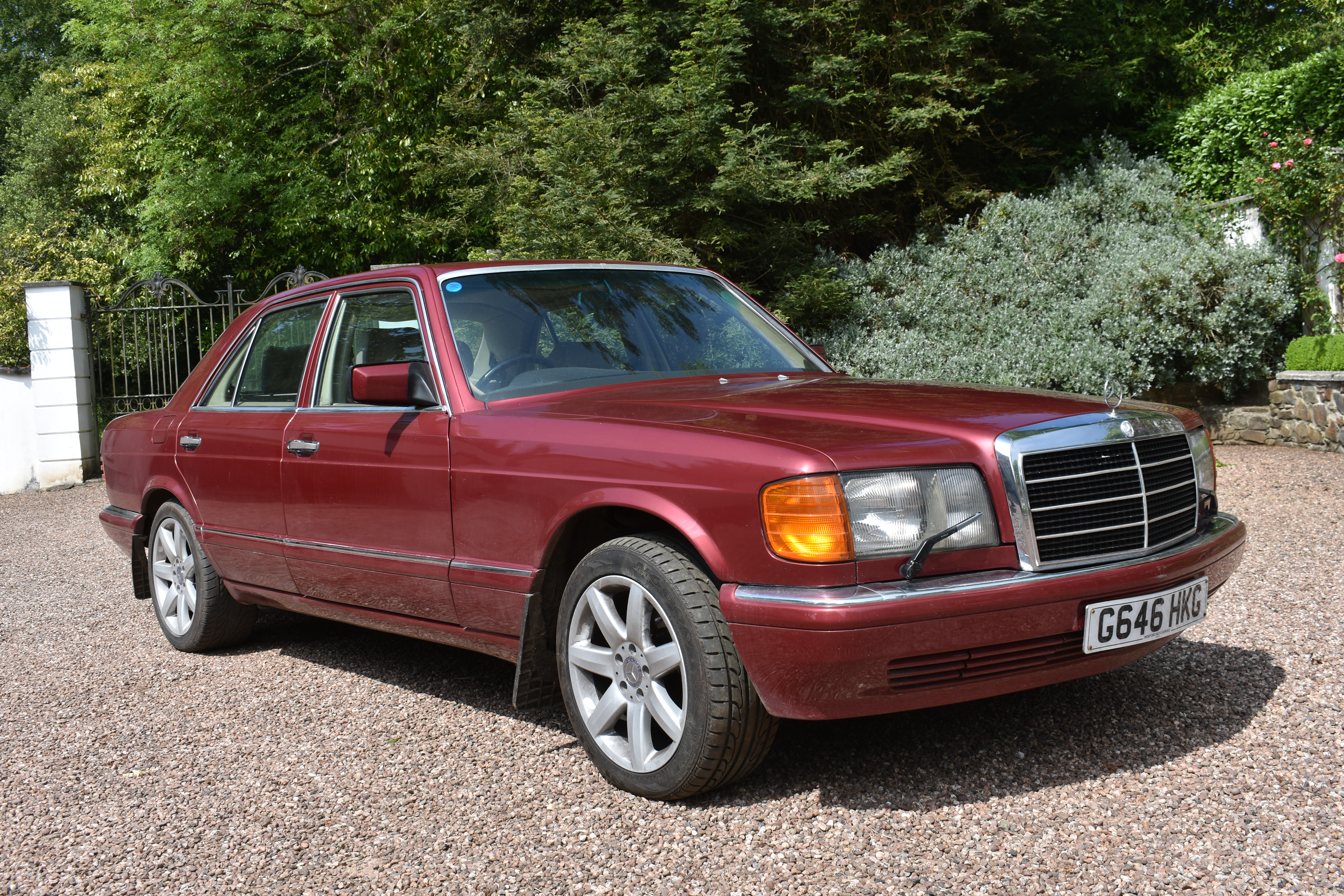 A 1990 Mercedes-Benz 420 SE saloon, registration number G646 HKG, Almandine metallic red. This 420SE