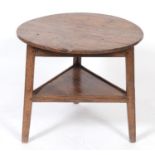 A 19th century oak cricket table, on a triangular base, 71 cm diameter See illustration Report by RB