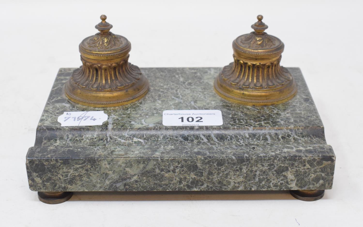 A marble inkstand, with two gilt metal inkwells with ceramic liners, 18 cm wide