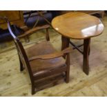 An Arts & Crafts oak occasional table, with a shaped top, 60 cm wide and an oak low armchair, with