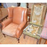 A wingback armchair, with leather upholstery and a 17th century style chair, with needlework