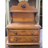 An Art Nouveau inlaid beech armchair, and a mahogany tabletop chest, with a shelf, 33 cm wide (2)