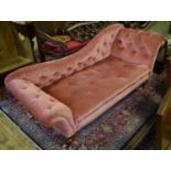A Victorian scroll end day bed, on peg feet