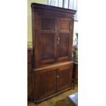 A 19th century oak floor standing corner cupboard, having two pairs of panel doors, 110 cm wide