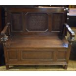 A carved oak monk's bench, 115 cm wide