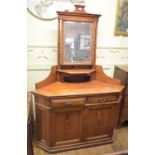 A Howard & Sons pine corner dressing table, the right panel door having an inset enamel makers