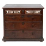 A late 17th/early 18th century oak chest, having four graduated long drawers, the top drawer